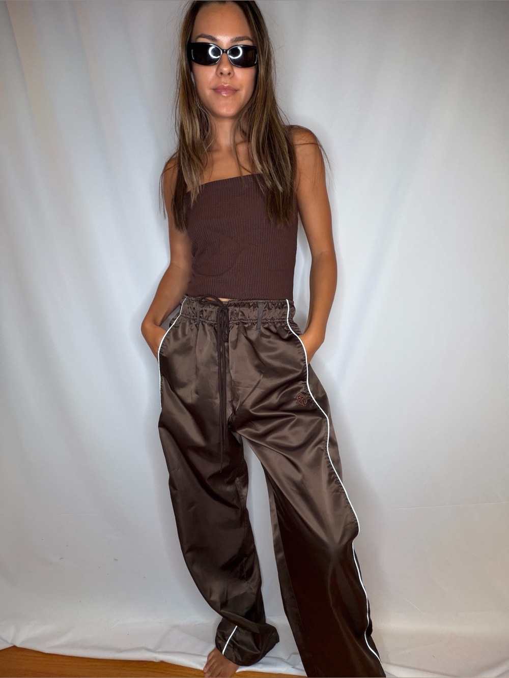 The open product brown Track Joggers with White Piping